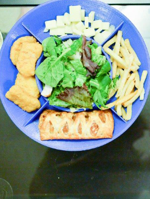 Colored bowl plate with mixed chips in the bowl portion and chicken nuggets and fries in the plate sections